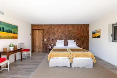 a bedroom with a bed and a wooden wall at Villa Mirage luxury and design in Bonnieux in Bonnieux