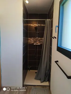 a bathroom with a shower with a shower curtain at Le Mas des Calus Chambres d'hôtes in LʼIsle-sur-la-Sorgue