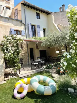 two inflatables in the grass in front of a building at B&B Temps Suspendu Provence in Pernes-les-Fontaines