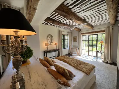 a bedroom with a large bed and a large window at Villa Hautvallon - Peaceful Escape in Provence in Gordes