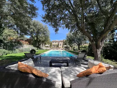 a swimming pool with chairs and a table next to a house at Villa Hautvallon - Peaceful Escape in Provence in Gordes