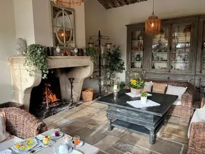 a living room with a table and a fireplace at Villa Hautvallon - Peaceful Escape in Provence in Gordes