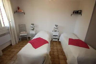 two beds in a room with white and red at Lou Cigalon in Cabrières-dʼAvignon