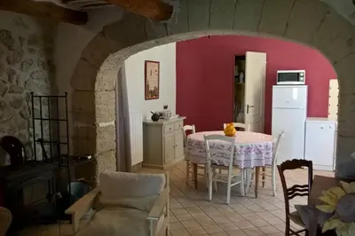a kitchen and dining room with a table and chairs at Gîte La Charlette in Cheval-Blanc