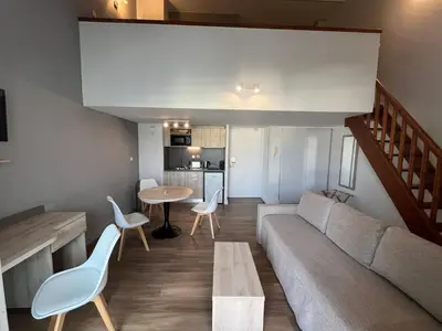 a living room with a couch and a table at Les appartements du Clos de la Chartreuse By Ateya in Aix-en-Provence