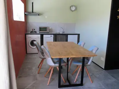 a kitchen with a table and chairs in a room at Le Mas du Fort in Gargas