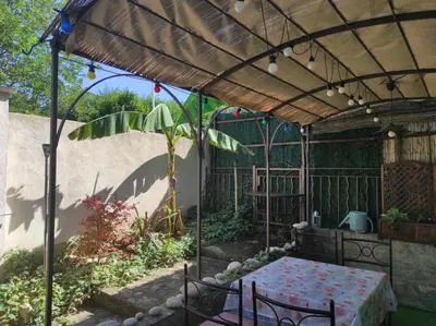 a patio with a table under a pergola at Au petit Florian en Provence in Apt