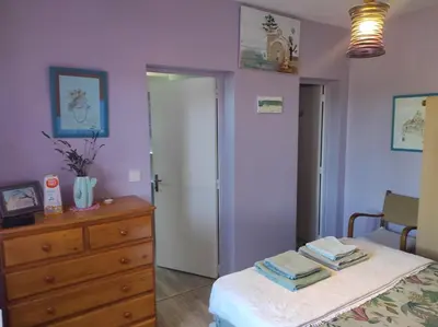 a bedroom with a bed and a dresser and a mirror at Au petit Florian en Provence in Apt