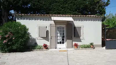 a small white house with a white door at Mas Grimaud - Gîte- Studio et chambres d'hôtes familiales in Eygalières
