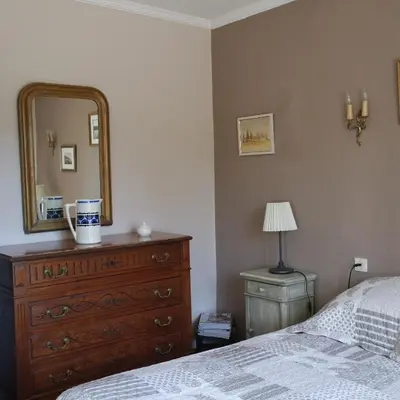 a bedroom with a dresser and a mirror at Mas Grimaud - Gîte- Studio et chambres d'hôtes familiales in Eygalières