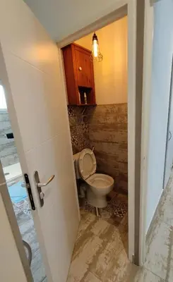 a bathroom with a toilet in a room at Charmante Maison au pied du Luberon in Cheval-Blanc