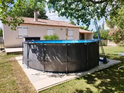 a pool in the yard of a house at Charmante Maison au pied du Luberon in Cheval-Blanc