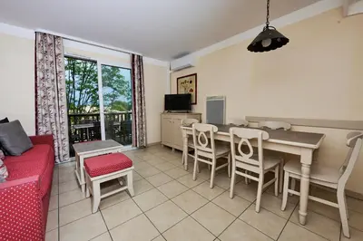 a living room with a table and chairs at Bastidon Golf de Pont Royal in Mallemort