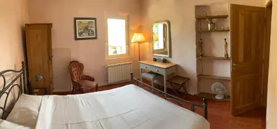 a bedroom with a bed and a desk and a mirror at Auberge de Mazan in Mazan