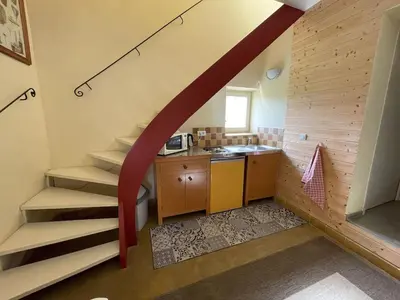 a small kitchen with a staircase in a house at Auberge de Mazan in Mazan