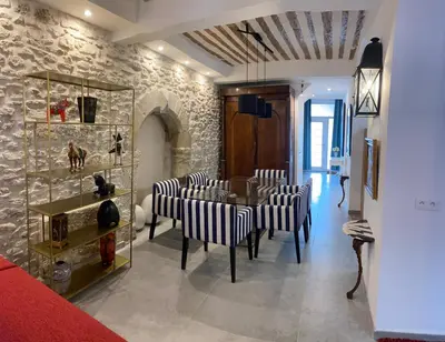 a dining room with a table and some chairs at La RENAUDIERE in LʼIsle-sur-la-Sorgue
