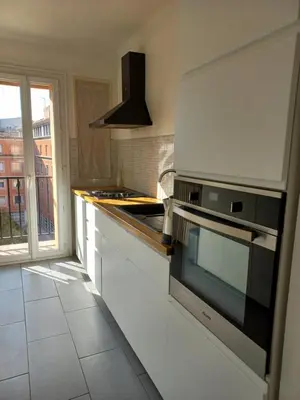 a kitchen with white cabinets and a stove top oven at Aix en Provence - Rotonde - Cours Mirabeau in Aix-en-Provence