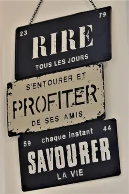 three signs hanging on a wall in a restaurant at Coin de paradis en Provence in Saint-Cannat