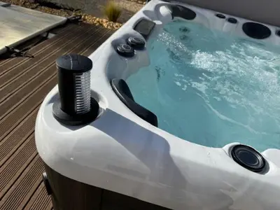 a jacuzzi hot tub with a black at Imola - Côté Ventoux in Bédoin