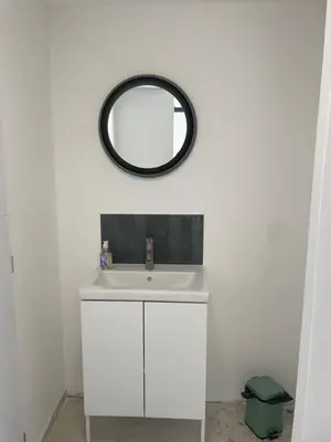 a bathroom with a white sink and a mirror at Villa avec Pool House au cœur des vignes - Lubéron in La Tour-dʼAigues