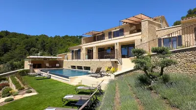 a large house with a swimming pool in a yard at Mas La Rose Sauvage - magnificent Luberon views in Murs