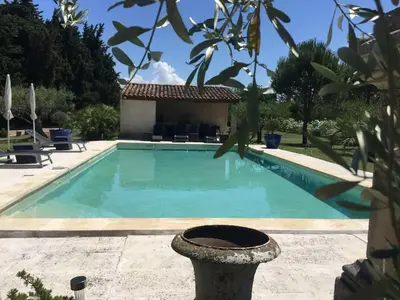 a swimming pool in front of a house at Mas du Soleil in Caumont-sur-Durance