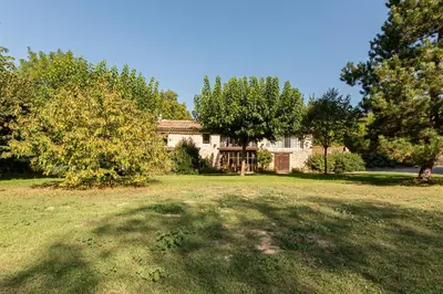 a large house with a large yard with trees at Mas Titourin - Moulin du 18ème entièrement rénové in Ansouis