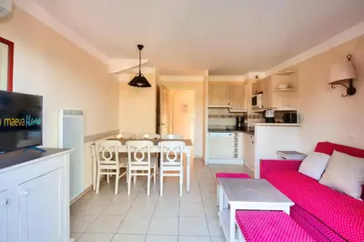 a living room with a red couch and a table at Les Coteaux de Pont Royal en Provence - maeva Home - Maison climatisée 3 pièces 6 personnes - Sélection MAE-5714 in Mallemort