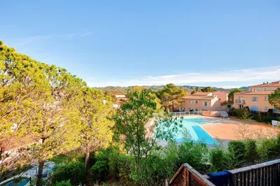 a view of a swimming pool with trees and houses at Les Coteaux de Pont Royal en Provence - maeva Home - Maison climatisée 3 pièces 6 personnes - Sélection MAE-5714 in Mallemort
