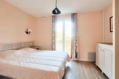 a bedroom with a large bed and a window at Les Coteaux de Pont Royal en Provence - maeva Home - Maison climatisée 3 pièces 6 personnes - Sélection MAE-5714 in Mallemort