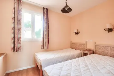 a bedroom with two beds and a window at Les Coteaux de Pont Royal en Provence - maeva Home - Maison climatisée 3 pièces 6 personnes - Sélection MAE-5714 in Mallemort