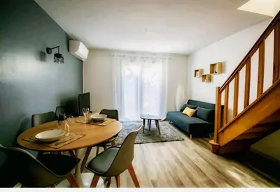 a living room with a table and a couch at Les quatre loges n°1 in Aix-en-Provence