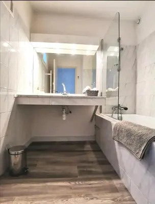 a bathroom with a sink and a tub and a mirror at Les quatre loges n°2 in Aix-en-Provence