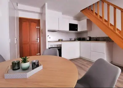 a kitchen and dining room with a wooden table at Les quatre loges n°2 in Aix-en-Provence