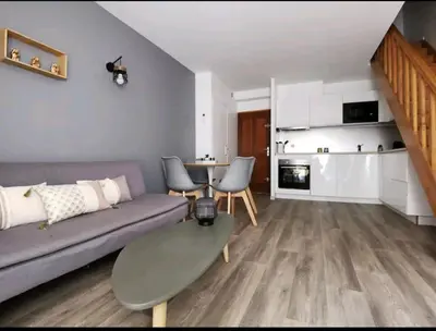 a living room with a couch and a table at Les quatre loges n°2 in Aix-en-Provence