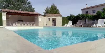 a swimming pool in front of a house at Chambres d'hôtes Le Saint Victor - Provence, Vaucluse in Pernes-les-Fontaines