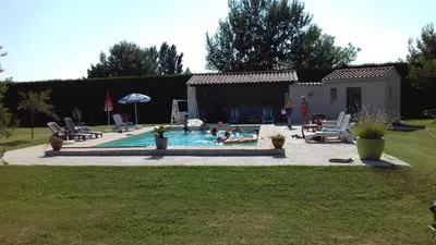 a group of people in a swimming pool at Chambres d'hôtes Le Saint Victor - Provence, Vaucluse in Pernes-les-Fontaines