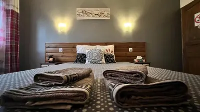 a bedroom with a bed with towels on it at Chambres d'hôtes Le Saint Victor - Provence, Vaucluse in Pernes-les-Fontaines