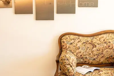a chair with a book and pictures on the wall at Mas Saint Julien in Cavaillon