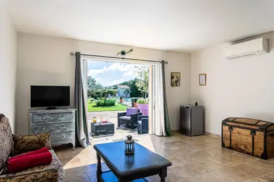 a living room with a couch and a tv at Mas Saint Julien in Cavaillon