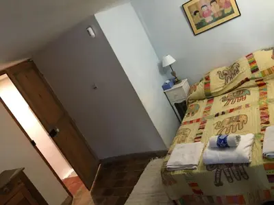 a small bedroom with a bed and a staircase at FLC - Large Charming House - Swimming Pool in Lambesc