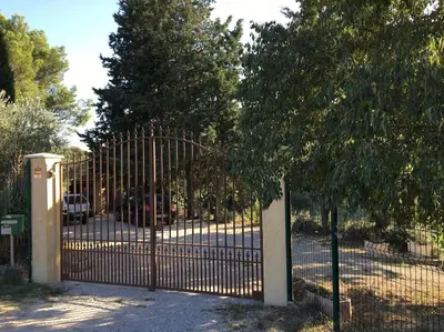 a metal gate with a tree in front of it at FLC - Large Charming House - Swimming Pool in Lambesc