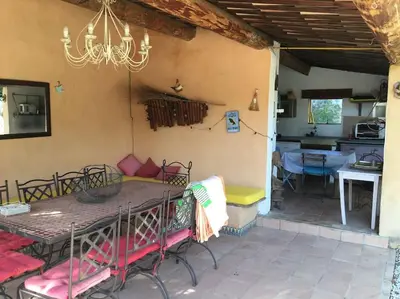a dining table and chairs on a patio at FLC - Large Charming House - Swimming Pool in Lambesc