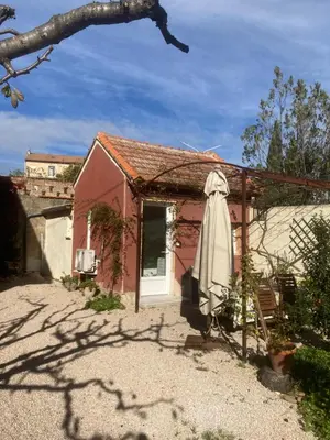 a red house with an umbrella in front of it at 