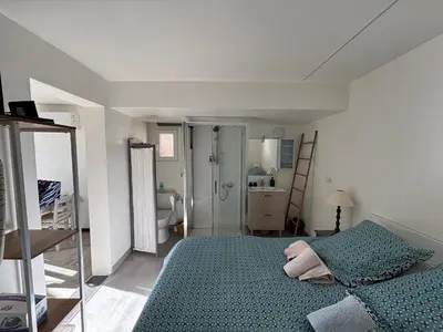 a bedroom with a green bed and a bathroom at 