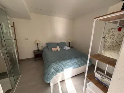 a small bedroom with a bed and a mirror at 