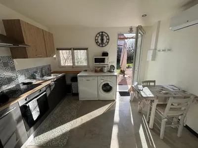 a kitchen with a washing machine and a table at 