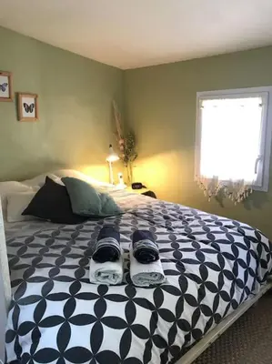 a bedroom with a bed with shoes on it at Maisonnette au pied du Mont Ventoux ste colombe in Bédoin
