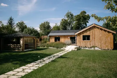 a log home with a garden and a house at Charming ecolodge with private access to the river in Le Thor