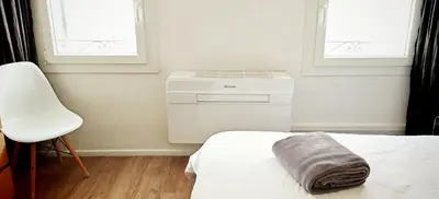 a bedroom with a air conditioner in a room at Studio centre historique 200 m de la mairie - Climatisé in Aix-en-Provence